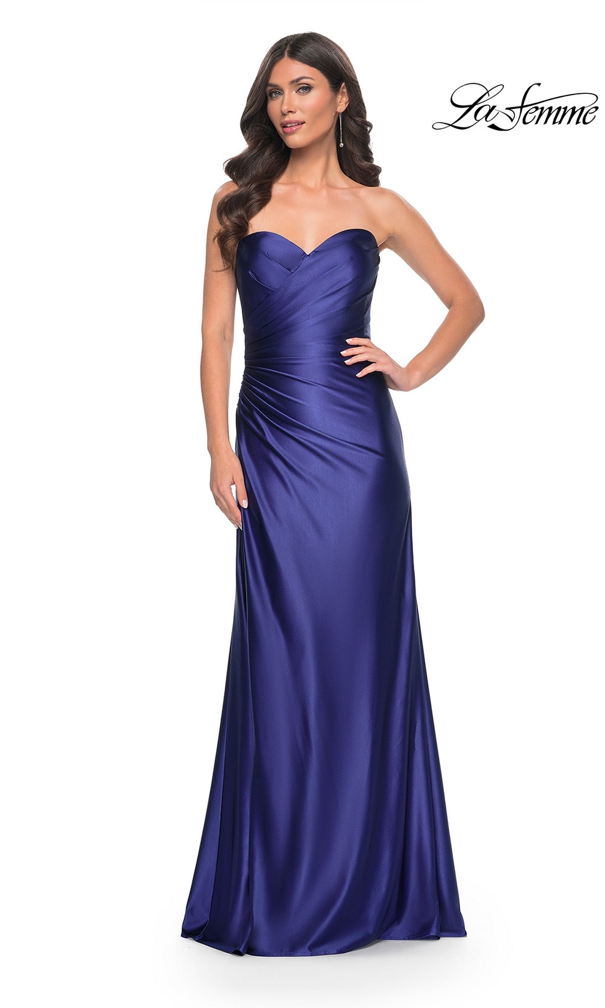 Model wearing the La Femme Strapless Sweetheart Long Prom Dress 32159, a floor-length royal blue gown with a ruched bodice and corset-back, standing against a white background.